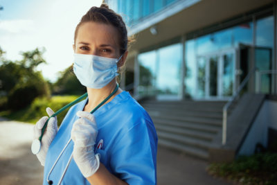 modern physician woman in scrubs with stethoscope